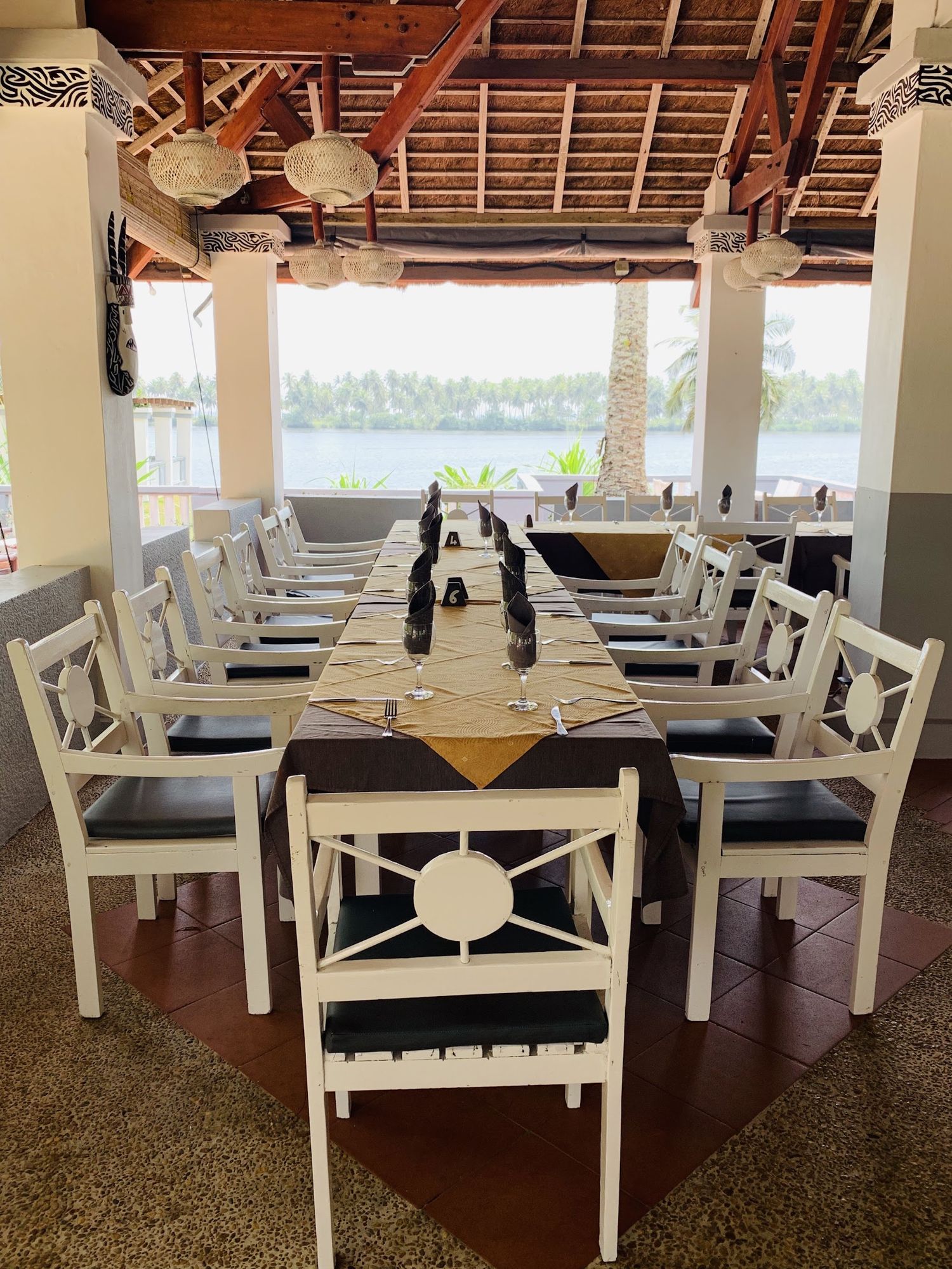 Salle de restaurant dressée, ouverte sur la lagune